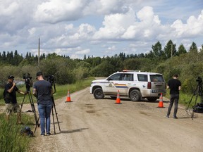 Police block the road as they investigate a plane crash in Leduc County Alta, on Wednesday July 3, 2020. The Transportation Safety Board says an amateur-built plane was training with amphibious floats when it went down last week south of Edmonton, killing three people on board.THE CANADIAN PRESS/Jason Franson