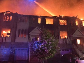 Firefighters are battling a massive blaze in Hamilton that has claimed 11 townhouses.