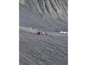 RCMP in Alberta say there are reports that multiple people are injured after a bus, similar to the vehicle pictured, rolled over on a highway that runs between Jasper and Banff National Parks. Responders attend to a rolled-over icefield touring bus in Jasper National Park, Alta., in a handout photo taken Saturday, July 18, 2020.