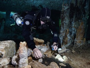 A paper published Friday in the journal Science Advances says there is evidence of people prospecting for the red pigment thousands of years ago in what is today the state of Quintana Roo. A diver from the Centro Investigador del Sistema Acuífero de Quintana Roo (CINDAQ) collects charcoal samples in the oldest ochre mine ever found in the Americas, used 10,000-12,000 years ago by the earliest inhabitants of the Western hemisphere to mine the pigment mineral red ochre. The charcoal is thought to come from wood burned to light the cave for the ancient miners.