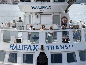 Passengers wear face masks on a Halifax Transit ferry as it arrives in Dartmouth, N.S. on Friday, July 24, 2020, the first day they have been mandatory on public transit. Starting at the end of the month, Nova Scotians will be expected to wear non-medical masks in most indoor public spaces. Nova Scotia has now gone nine days with no new cases of COVID-19.