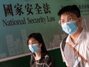 Pedestrians walk past a government-sponsored advertisement promoting a new national security law on July 15, 2020 in Hong Kong, China.