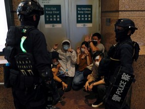 People detained by riot police during a march against national security law at the anniversary of Hong Kong's handover to China from Britain in Hong Kong, China July 1, 2020.