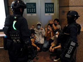 People are detained by riot police during a march against the national security law on the anniversary of Hong Kong's handover to China from Britain, in Hong Kong on July 1.