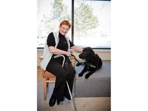 Ann Moxley poses with her dog Gretzky in this undated handout photo. If the past three months without a service dog have been a challenge for Moxley, the next year seems poised to be a struggle.