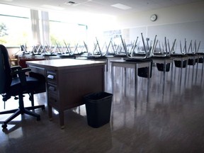 An empty teacher's desk is seen at the front of a empty classroom at McGee Secondary school in Vancouver on September 5, 2014. Alberta is planning to reopen schools in the province this fall even as cases of COVID-19 in the province continue to grow.