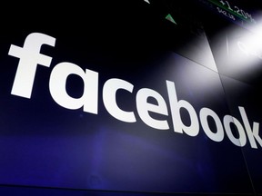 A Facebook logo is shown on screens at the Nasdaq MarketSite in New York's Times Square on March 29, 2018. A First Nations elder who led mediation circles after a social media post called for violence against Indigenous people says she is disappointed one of three women arrested has not faced consequences. "We do not accept racism," said Irene Young.