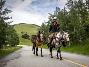Filipe Masetti Leite, a Brazilian cowboy who has been riding from Alaska to Calgary and who has also been chosen as the parade marshal for the Calgary Stampede, rides his pony Smokey as pack pony Mack follows along near Waiparous Village, Alta., Monday, June 29, 2020.