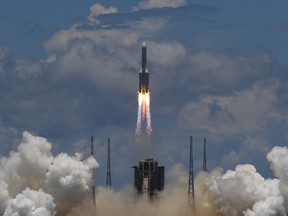 A Long March-5 rocket, carrying an orbiter, lander and rover as part of the Tianwen-1 mission to Mars, lifts off from the Wenchang Space Launch Centre in southern China’s Hainan Province on July 23, 2020.