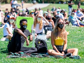 People wearing masks attend "Fuck The Fourth" Anti-Independance Day Rally organized by Black Women Lead, July 4, 2020, in Los Angeles, California.