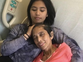 Mara Soriano, top, holds her mother Marilyn in a hospital in an undated handout photo. Soriano is pleading for the return of a teddy bear that speaks words recorded by her mother before she died of cancer in June 2019.