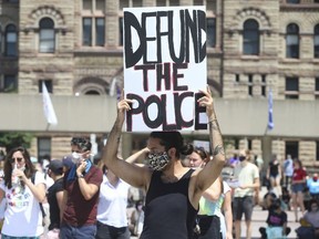 Protesters call for the defunding of police forces, at a downtown Toronto rally on June 28, 2020.