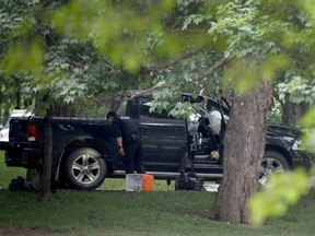 OTTAWA - RCMP stand guard outside the grounds of Rideau Hall in Ottawa Thursday July 2, 2020. An armed man was arrested early Thursday on the grounds of 1 Sussex Drive, the official residence of the prime minister and the Governor General. Police explosives robot was used to search a four-door black Dodge Ram with the air bags deployed on the grounds Thursday. Police search the truck.  Tony Caldwell