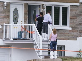 Police investigate the scene where a six-year-old girl was stabbed overnight and later died in Montreal on Thursday, July 23, 2020. Montreal police said today they are considering her death a homicide.