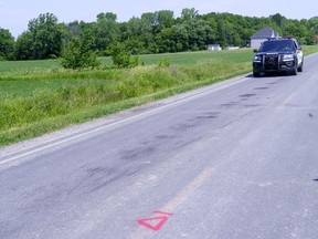 A police car drives along le Rang Sainte-Anne in Notre-Dame-de-Stanbridge, Que. on Thursday, July 2, 2020 where three children aged five and under died following a tractor accident Wednesday evening.