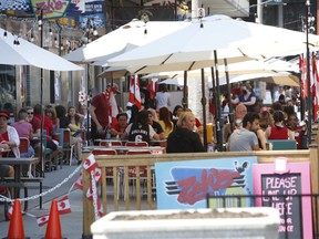 People sit on a patio in the ByWard Market on Canada Day in Ottawa, Ontario, Canada, on Wednesday, July 1, 2020.