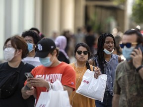 Some choose to wear masks and some do not at Toronto's Dundas Square during the Covid-19 pandemic, Monday July 6, 2020.