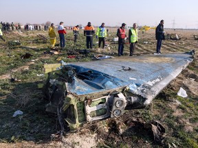 In this file photo taken on January 08, 2020 rescue teams are seen on January 8, 2020 at the scene of a Ukrainian airliner that crashed shortly after take-off near Imam Khomeini airport in the Iranian capital Tehran.