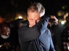 Portland Mayor Ted Wheeler reacts after being exposed to tear gas fired by federal officers while attending a protest against police brutality and racial injustice in front of the Mark O. Hatfield U.S. Courthouse on July 22, 2020 in Portland, Ore.