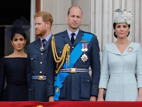 Left to right: Meghan Prince Harry, Prince William and Catherine stand on the balcony of Buckingham Palace on July 10, 2018 to watch a military fly-past to mark the centenary of the Royal Air Force (RAF).