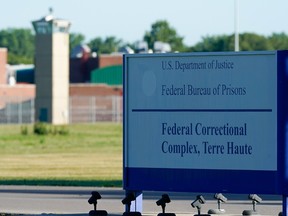 A  sign stands outside the Federal Correctional Institution, Terre Haute, as Daniel Lewis Lee, convicted in the killing of three members of an Arkansas family in 1996, is set to be put to death in the first federal execution in 17 years, in Terre Haute, Indiana, U.S. July 13, 2020.