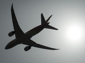 A plane is silhouetted as it takes off from Vancouver International Airport in Richmond, B.C., Monday, May 13, 2019. A new poll suggests turbulence ahead for airlines seeking public support for their current COVID-19 plans.THE CANADIAN PRESS/Jonathan Hayward