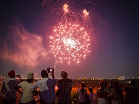 People watch a fireworks show in Centennial park as part of Canada Day celebrations, in Toronto on Sunday, July 1, 2018. Fireworks companies say they've seen a surge in consumer sales in recent weeks as people try to recreate cancelled Canada Day displays.