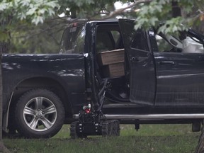 A police robot approaches a pickup truck inside the grounds of Rideau Hall in Ottawa on Thursday, July 2, 2020. The man accused of ramming through a gate at Rideau Hall while heavily armed is staying in an Ontario jail for another three weeks.
