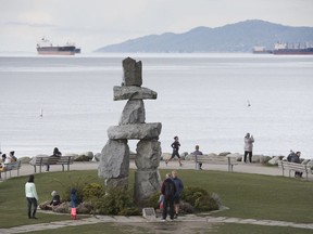 People attempt to physical distance themselves from one another as they walk along the seawall in Vancouver, Tuesday, March 31, 2020. British Columbia's tourism and hospitality sector believes it should receive more than one-third of the $1.5-billion COVID-19 recovery package pledged to the province by the federal government.THE CANADIAN PRESS/Jonathan Hayward