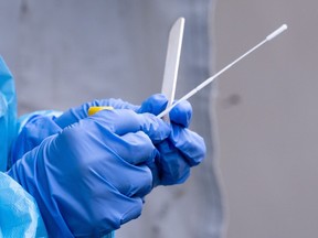 A nurse gets a swab ready at a temporary COVID-19 test clinic in Montreal, on Friday, May 15, 2020. A hospital in west Edmonton says it is no longer admitting patients due to a full outbreak of COVID-19.THE CANADIAN PRESS/Paul Chiasson