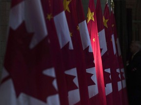 A Chinese flag is illuminated by sunshine in the Hall of Honour on Parliament Hill in Ottawa, Thursday, September 22, 2016. China is threatening retaliation against Canada after Prime Minister Justin Trudeau condemned a new security law giving Beijing more control over Hong Kong..
