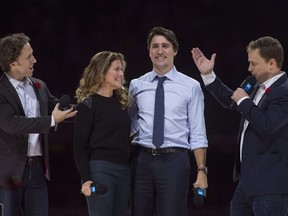 Co-founders Craig (left) and Marc Kielburger introduce Prime Minister Justin Trudeau and his wife Sophie Gregoire-Trudeau as they appear at the WE Day celebrations in Ottawa, Tuesday November 10, 2015.