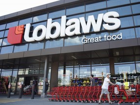 A customer wearing a protective mask exits a Loblaws store in Ottawa, Ontario, Canada, on Friday, July 10, 2020.