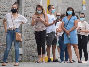 People wait to be tested for COVID-19 at a testing clinic in Montreal, Sunday, July 12, 2020, as the COVID-19 pandemic continues in Canada and around the world.