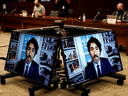 Prime Minister Justin Trudeau is seen on screens as he testifies to a House of Commons finance committee meeting via video conference, in Ottawa on July 30, 2020.