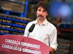 In this file photo taken on July 3, 2020 Canadian Prime Minister Justin Trudeau speaks to the press as he volunteers at the Moisson Outaouais food bank in Gatineau, Quebec, Canada during the coronavirus pandemic.