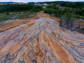 An aerial view taken on June 27, 2020 shows orange-coloured rivers fanning out over the forested landscape near a disused copper-sulphide mine near the village called Lyovikha in the Urals.
