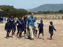 Free the Children founder Craig Kielburger walks with Maasai students who attend Ol'Museregi Primary School, which was recently built by Kielburger’s charity.