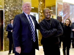 In this file photo taken on December 13, 2016 singer Kanye West and President-elect Donald Trump speak with the press after their meetings at Trump Tower in New York.
