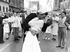 As pedestrians watch, an American sailor passionately kisses a white-uniformed nurse in Times Square to celebrate the long-awaited victory over Japan on Aug. 14, 1945.