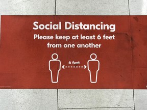 Social and physical distancing signs are pictured on the floors of various business throughout Vancouver and surrounding area