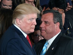 Chris Christie speaks with U.S. President Donald Trump(L) after he delivered remarks on combatting drug demand and the opioid crisis on October 26, 2017 in the East Room of the White House in Washington, D.C.