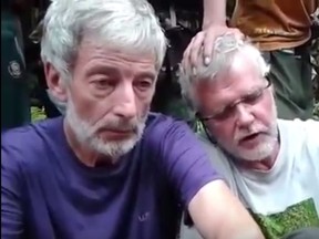 Robert Hall, 50, (in purple on left) and John Ridsdel, 68, are seen in a hostage video.