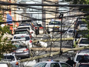 Power lines criss-cross at street level after Tropical Storm Isaias and its high winds heavy rain passed through on August 4, 2020 in Guttenberg, New Jersey.