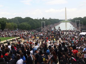 People listen as Martin Luther King III, eldest son of Rev. Martin Luther King Jr., speaks at the Lincoln Memorial during the 'Get Your Knee Off Our Necks' march in support of racial justice, in Washington, U.S., August 28, 2020.