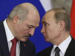 Russia's President Vladimir Putin (R) talks to his Belarus' counterpart Alexander Lukashenko as they attend a signing ceremony during a session of the Supreme State Council of the Union State at the Kremlin in Moscow on March 3, 2015.