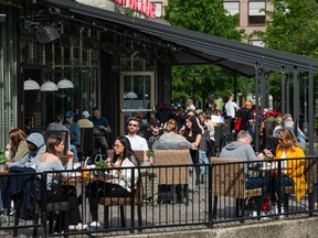 In this file photo taken on May 29, 2020 people sit in a restaurant in Stockholm, amid the coronavirus COVID-19 pandemic.