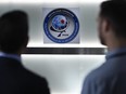 Two men stand at the headquarters of the General Directorate for External Security (DGSE), France's external intelligence agency, in Paris.