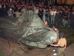 A crowd watches the statue of KGB founder Dzerzhinsky being toppled in Lubyanskaya square in Moscow, on Aug. 22, 1991.