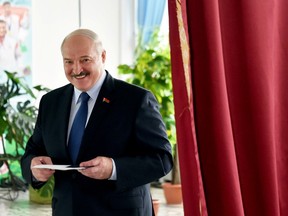 Belarusian President Alexander Lukashenko reacts as he visits a polling station during the presidential election in Minsk, on Aug. 9.